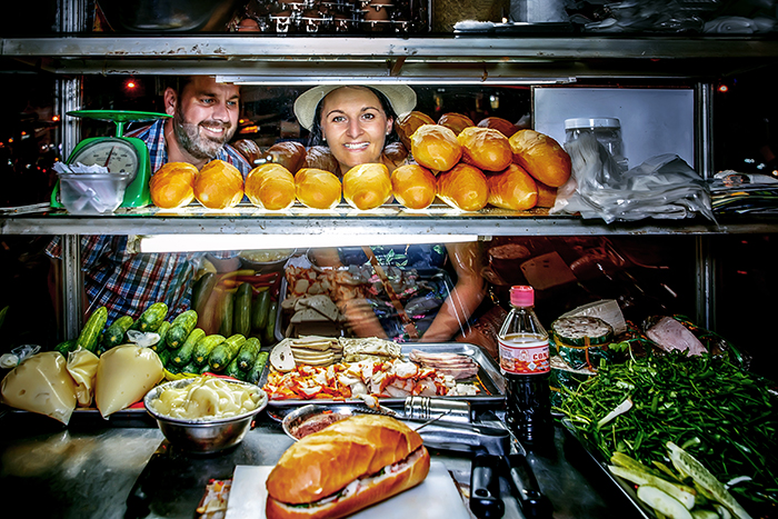 Tourists enjoy bánh mì. Photo: Tu The Duy